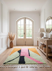 Modern Moroccan rug with pink and orange accents displayed in entryway