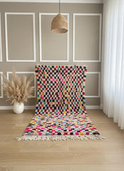 Pink Moroccan rug with fringe styled in modern interior