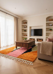 Colorful Moroccan area rug styled in neutral living space