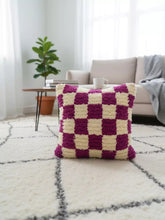 Tihlit Berber pillow on cream rug in modern living room setting