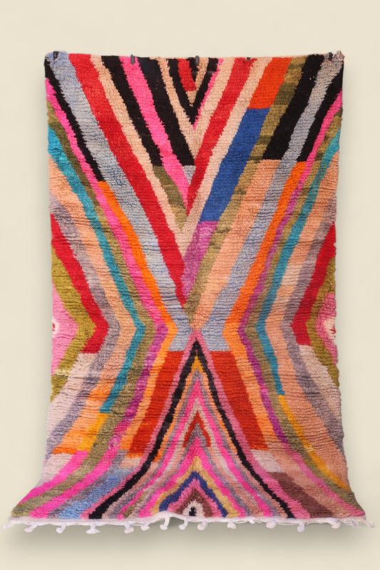 Moroccan Boucherouite rug featuring vivid rainbow-like zigzag patterns and soft wool texture