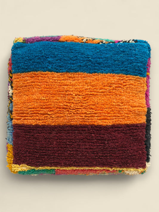Angled view of colorful Asmoun Moroccan floor cushion