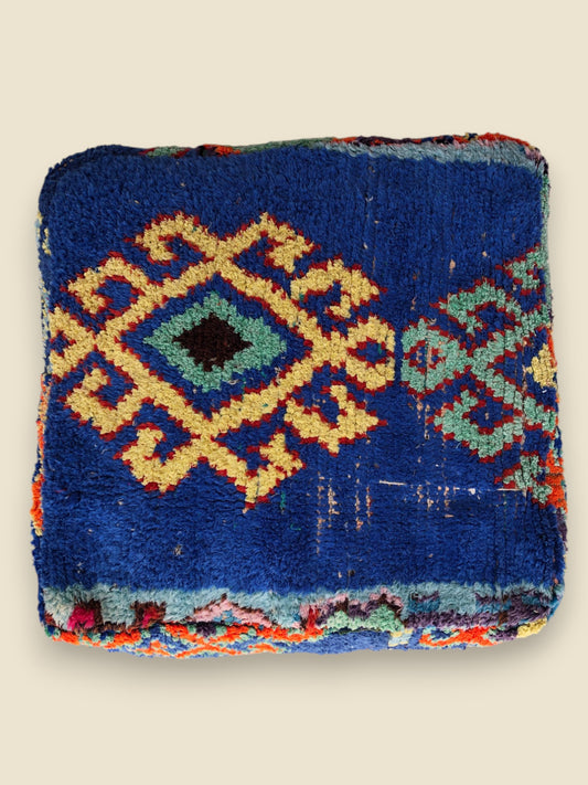 Handcrafted Ayyur Moroccan pouffe in natural tan leather, round and stitched with traditional Berber detailing.