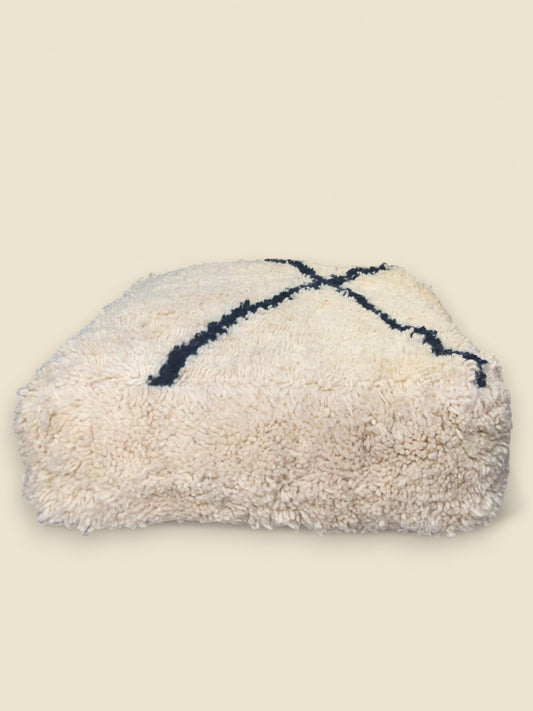 Side of Cream pouffe with bold black lines