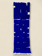 Blue textured rug on a beige background