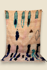 Full view of the Hafna rug showing symbolic tribal patterns and bold vertical accents.