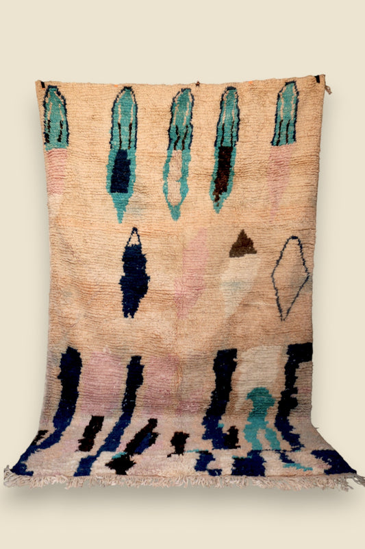 Full view of the Hafna rug showing symbolic tribal patterns and bold vertical accents.