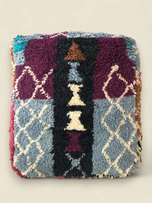 Top view of Asirem pouffe showing Berber diamond patterns and tribal accents