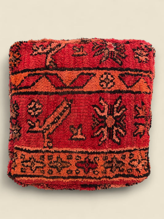 Top view of Berber pouffe with traditional geometric and animal motifs