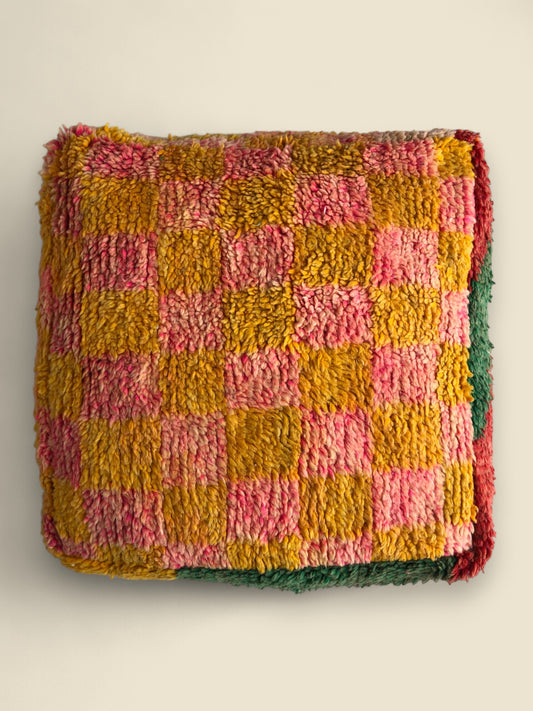 Colorful Moroccan pouffe with a pink and yellow checkered top