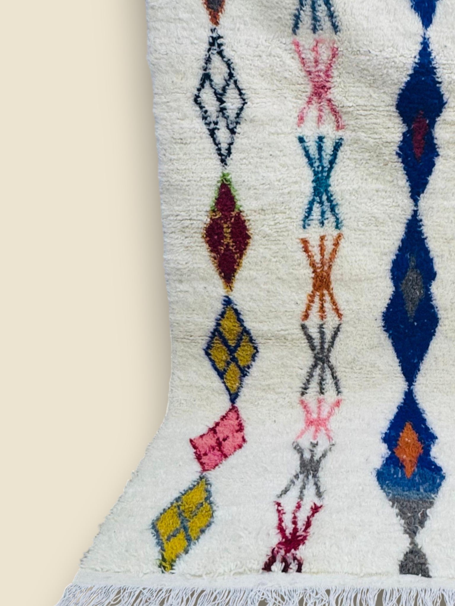 Handmade Massinissa Berber rug with colorful diamond patterns on white wool