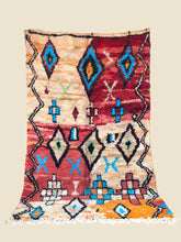 Colorful patterned rug with geometric design on a beige background