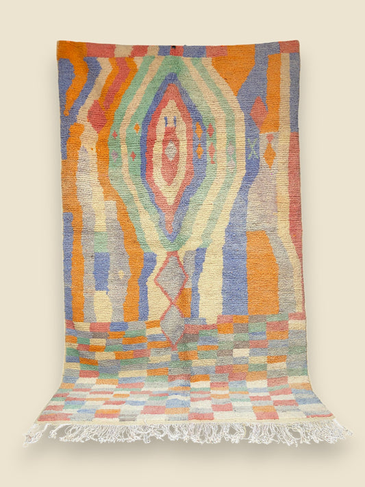 Handwoven Najat Moroccan rug with bold abstract diamond center and colorful block border in soft wool.