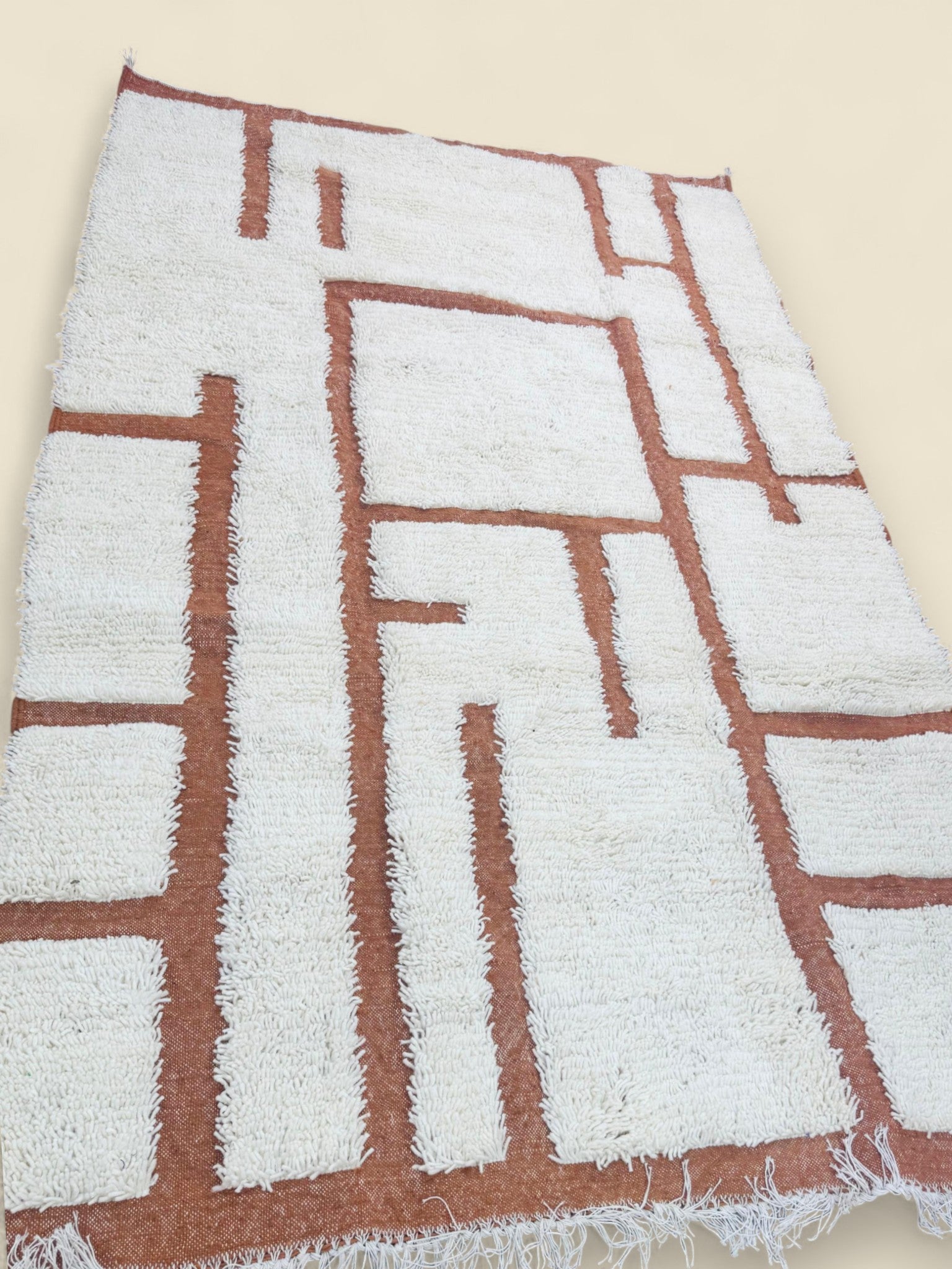 Handwoven Tafenzut Berber Rug with terracotta geometric lines on cream wool background