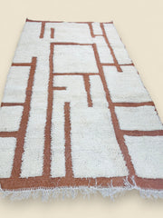 Close-up of Moroccan wool rug texture with cream pile and terracotta base