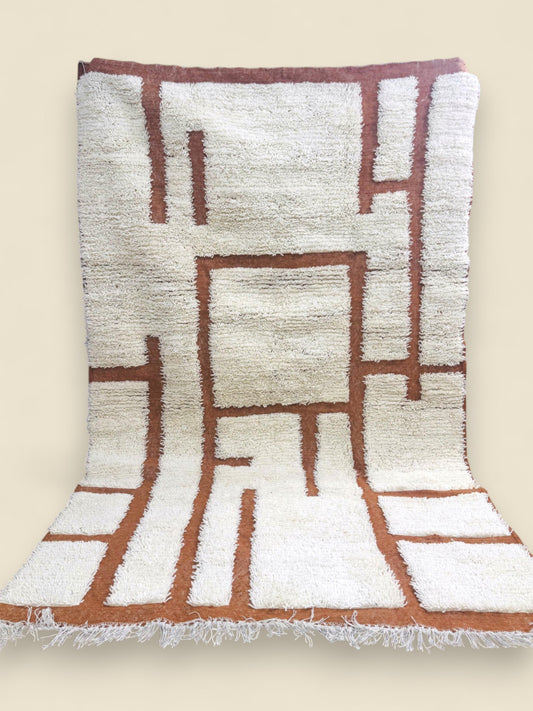Tafenzut handmade Berber rug showing geometric terracotta pattern and fringes