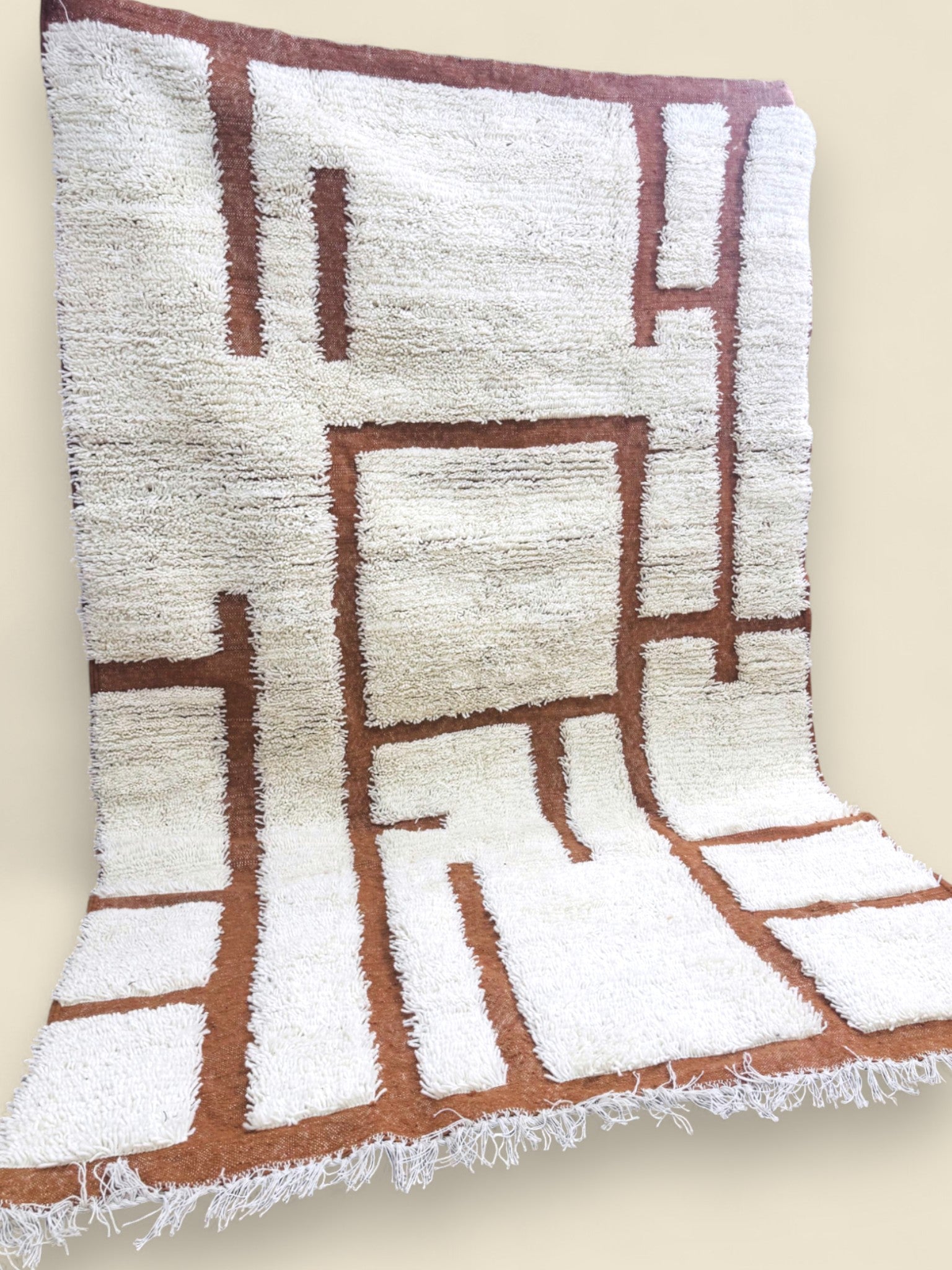 Moroccan wool rug displayed on wooden floor with modern abstract design