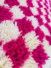 Close-up photo shows the details of the cream and pink wool
