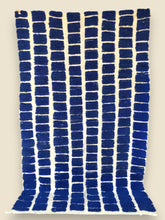 Full view of Tanit rug with vibrant blue geometric design