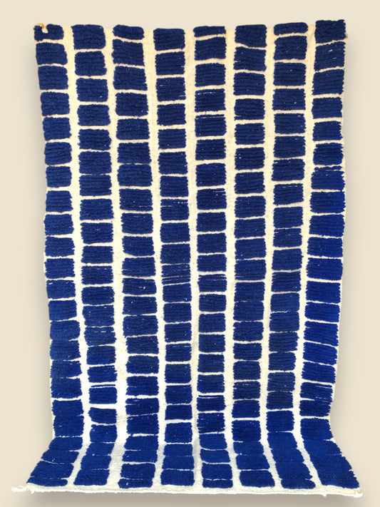 Full view of Tanit rug with vibrant blue geometric design