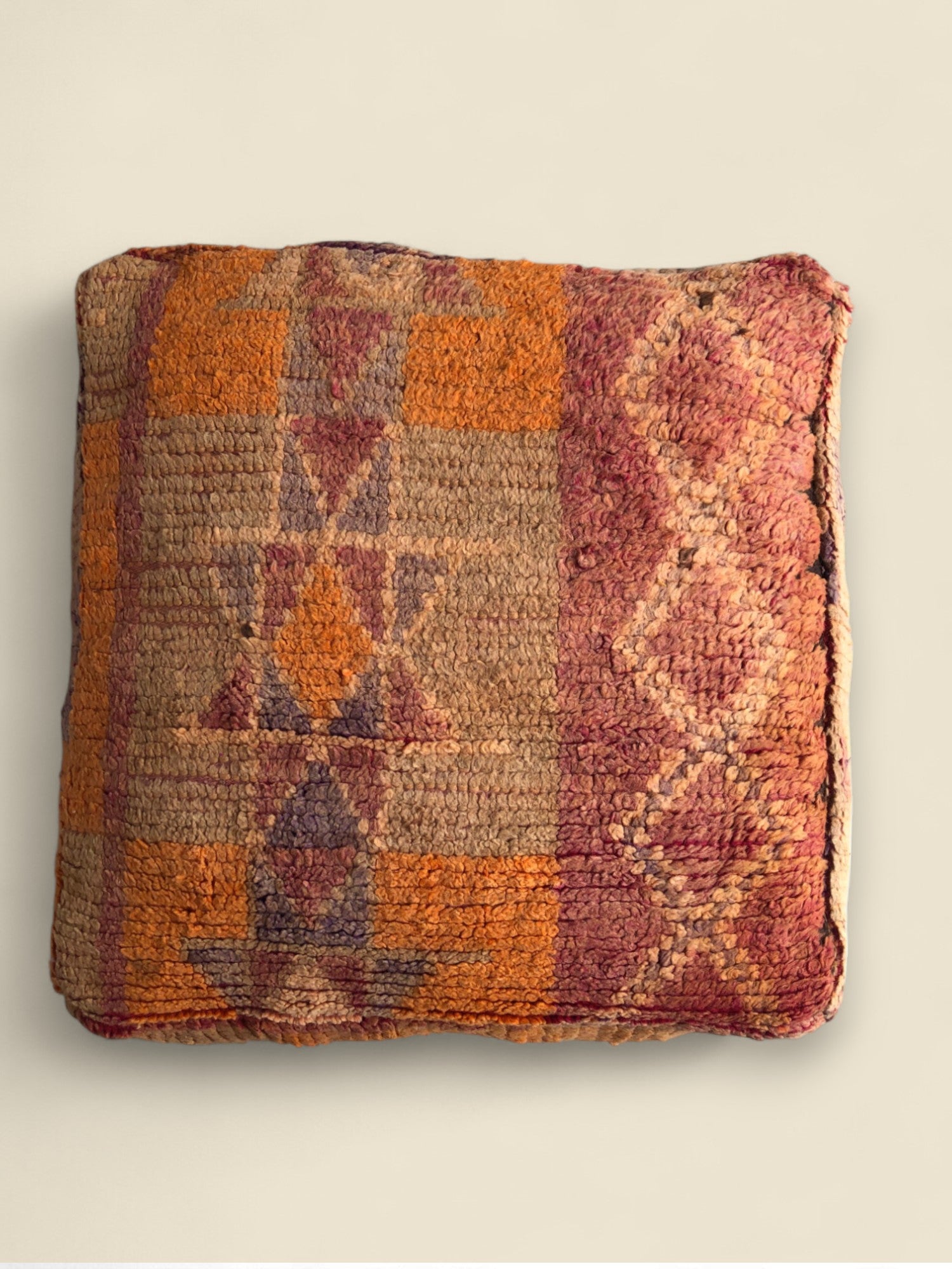 Square Moroccan floor pouffe with Berber motifs in earthy orange and beige tones