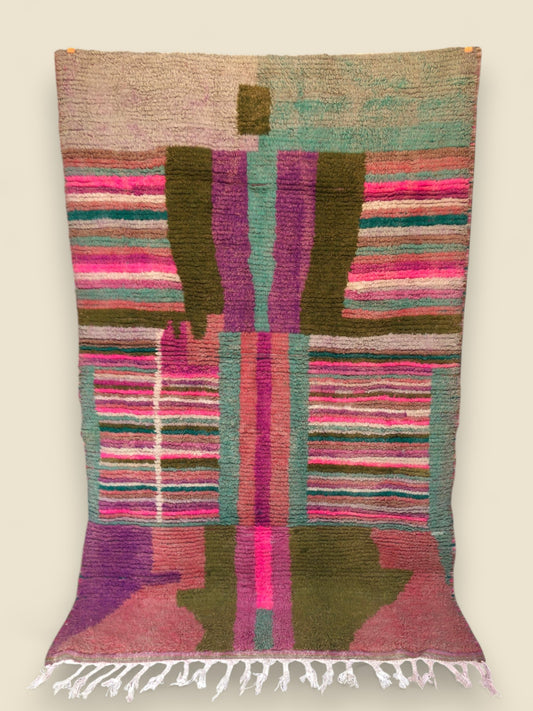Full view of Tazult Rug hanging, displaying bold central figure and colorful tribal patterns