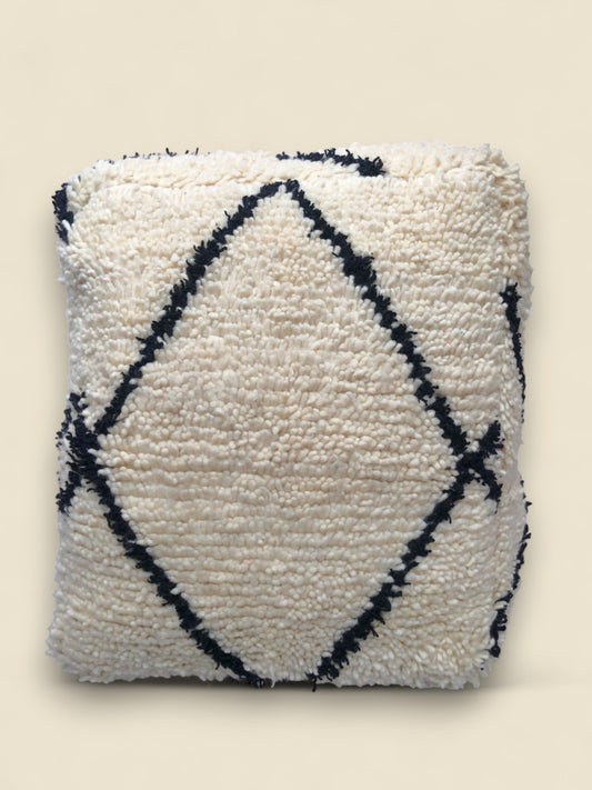 Cream Moroccan pouffe with black diamond design, handcrafted in wool