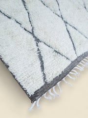 Berber wool rug with neutral tones and geometric pattern