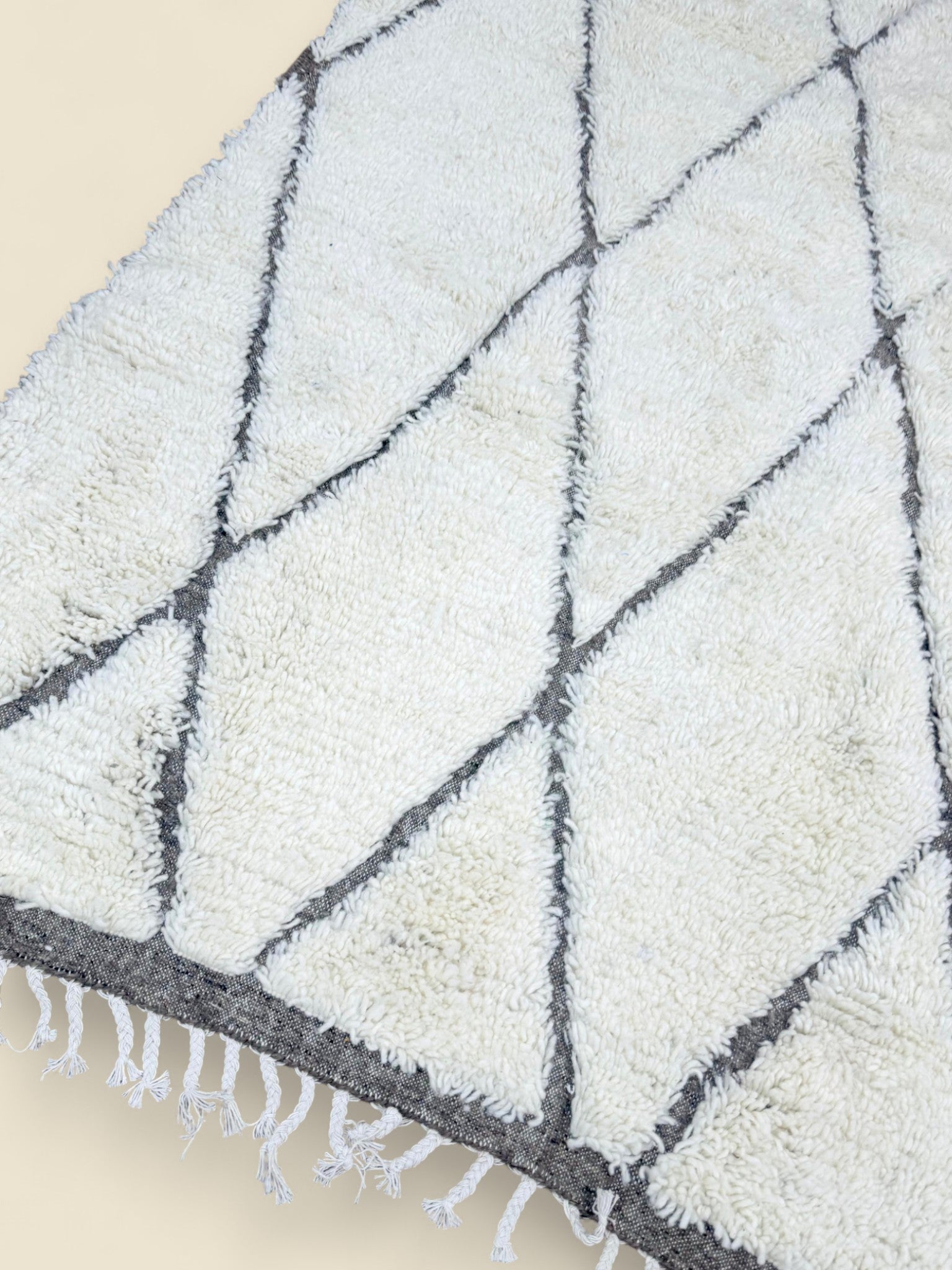 Close-up of Moroccan Tihya rug texture and fringed edge