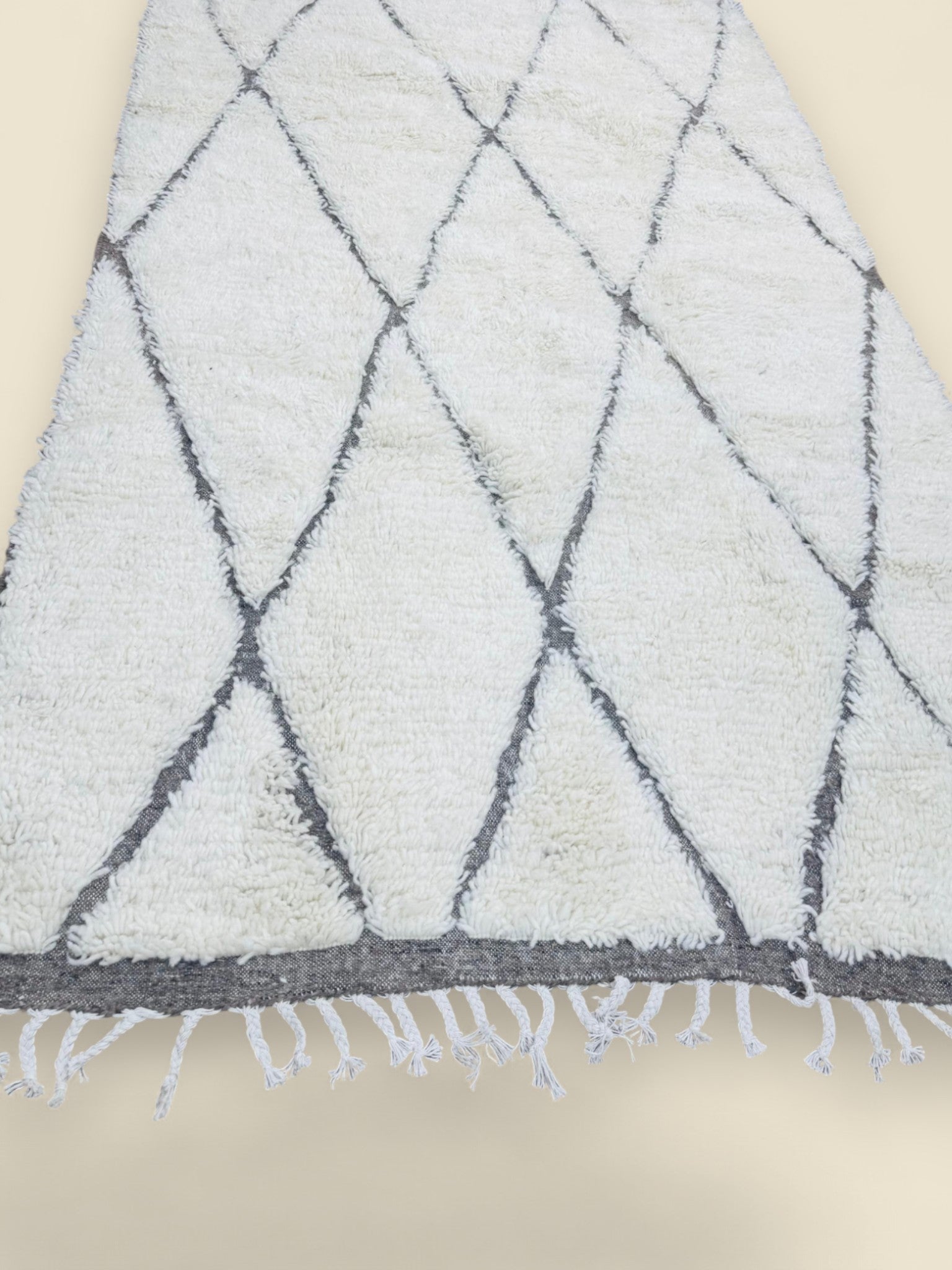 Soft ivory wool rug with handwoven diamond lines