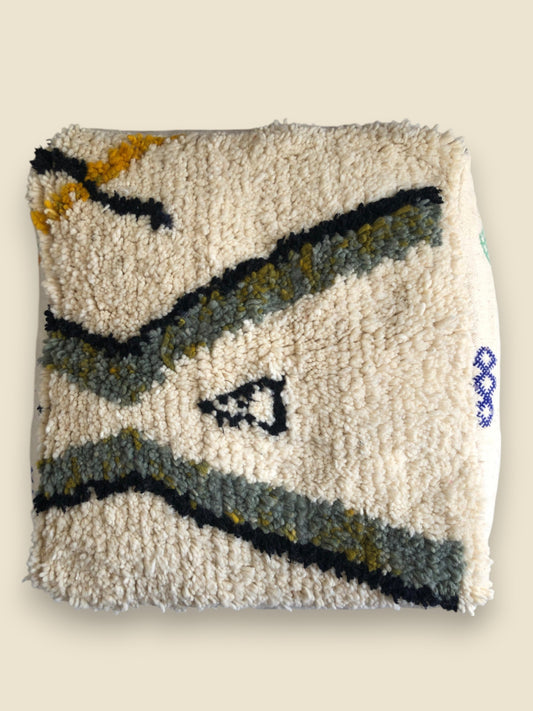 Top view of Tilyi pouffe showcasing full central motif in tribal style