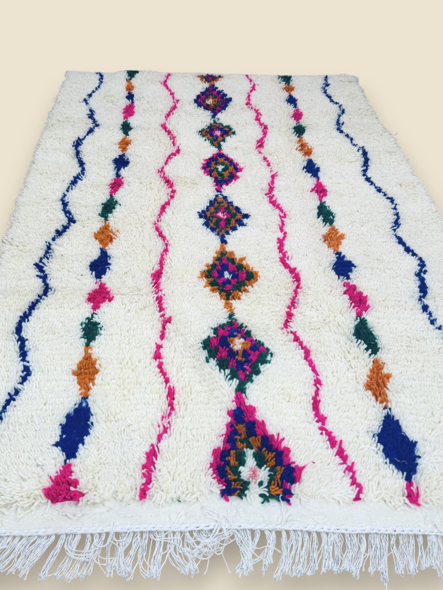 Side angle showing soft wool texture and vibrant Moroccan pattern