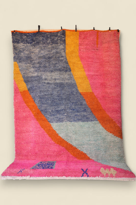 Handmade Moroccan rug in pink, blue, and orange with abstract geometric design