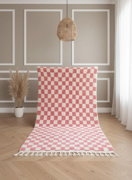 Handwoven pink checkered Berber rug displayed vertically