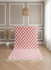 Handwoven pink checkered Berber rug displayed vertically