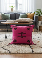 Handmade pink Sabra pillow with traditional Moroccan motifs displayed on a neutral sofa with boho decor.