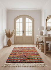 Handwoven Moroccan rag rug with tassels in entryway