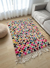 Multicolor Moroccan wool rug on wooden floor