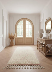 Soft pink Moroccan runner rug displayed in elegant neutral entryway