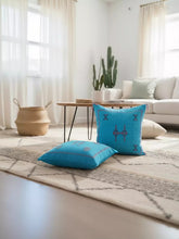 Pair of Tasga turquoise Berber pillows in modern Moroccan living room décor