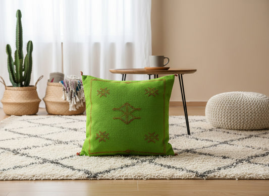Green Moroccan cactus silk pillow styled in a bohemian living room
