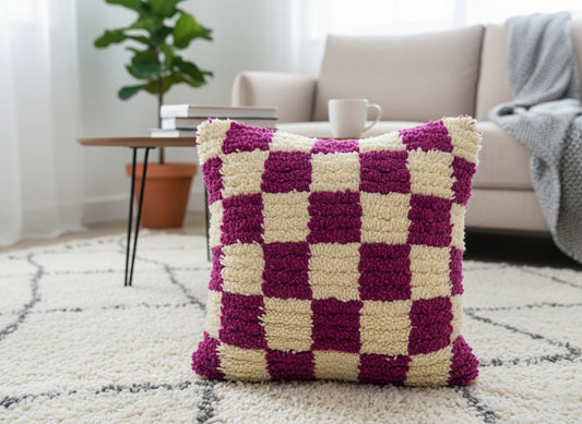 Tihlit Berber pillow on cream rug in modern living room setting
