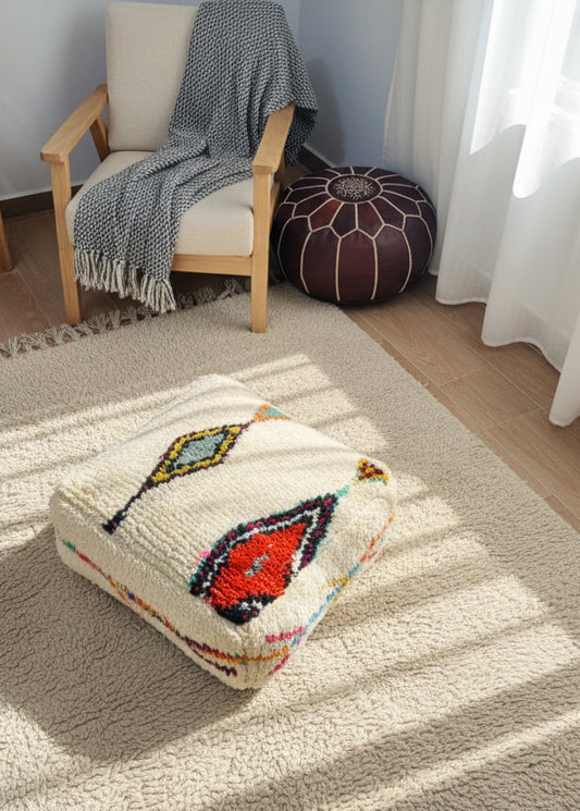 Moroccan Berber Amnay wool pouf styled in a cozy living room