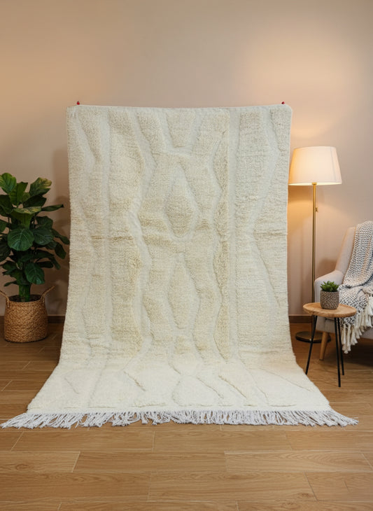 Textured beige wool rug with raised diamond pattern and tassels