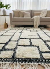 Tirina Berber wool rug with cream base and black geometric pattern in modern living room