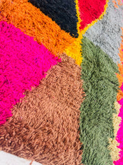 Close-up texture of Itto rug showing thick wool pile and vibrant colors