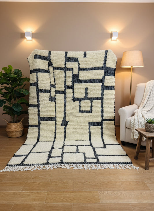 Tirina wool rug displayed vertically showing cream and black abstract design