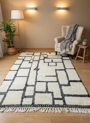 Modern Berber Tirina rug in cozy living space with armchair and warm lighting