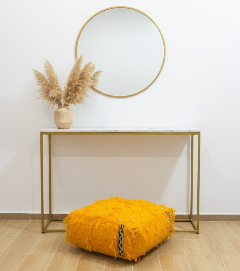 Yellow Berber pouf under a console table with pampas grass decor.
