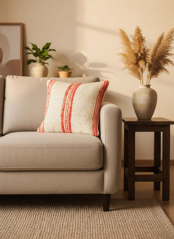 Red Stripe Moroccan wool pillow styled on a neutral sofa in a cozy modern living room.
